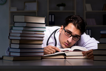 Medical student preparing for university exams at night