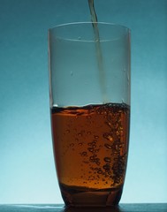 In a transparent glass goblet poured tea from the kettle.