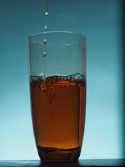 In a transparent glass goblet poured tea from the kettle.