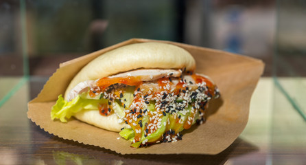 Chinese steamed bun with chicken, salad and sesame at food festival