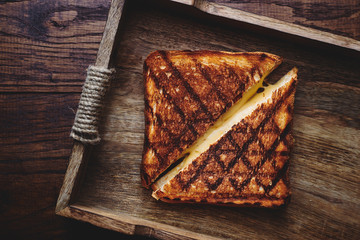 hot homemade sandwich with cheese in wooden box top view