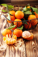 fresh mandarin oranges fruit with leaves in basket