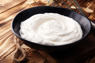 close up of a white whipped or sour cream in bowl