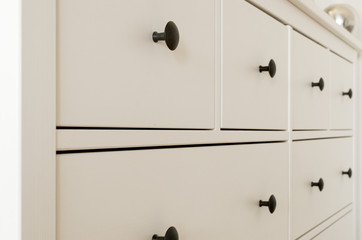 Drawers in white wooden chest of drawer, dresser