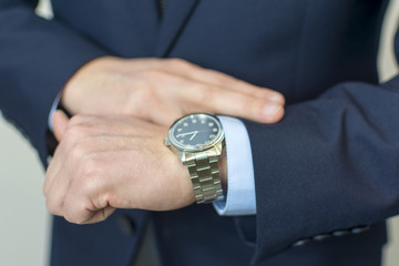 businessman looking at his watch on his hand