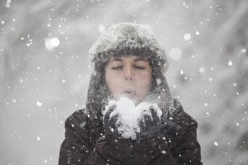Girl blowing snow