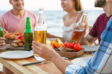 Young people having barbecue party at table