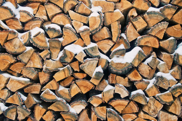background image of snow covered pile of firewood