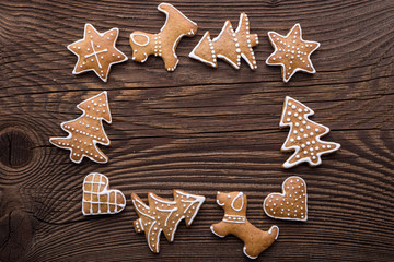 Gingerbread Christmas cookie background. Christmas homemade gingerbread cookies on wooden background.