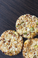 Homemade cornflakes and raisins cookies on old wooden table