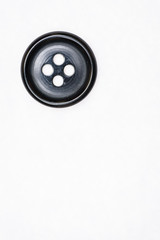 Sewing buttons on white background close up