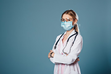 Cheerful happy doctor with mask on blue background