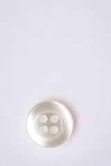 Sewing buttons on white background close up