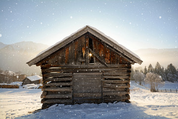 Winter landscape with old wooden hut and snowfall in christmas scenery, austrian Alps Pitztal -...