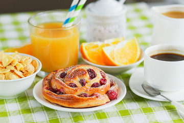Cup of coffee, baking, muesli and orange juice