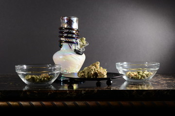 Cannabis with bong water pipe and hands o black  