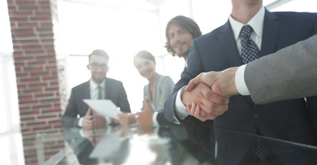 handshake of business partners in conference room
