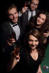 group of friends celebrating win at the casino.