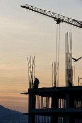 Silhouette of construction workers and building