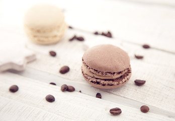 Composition with macaroons on a white rustic wooden background
