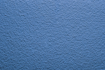 Blue paint closeup wall pattern background.