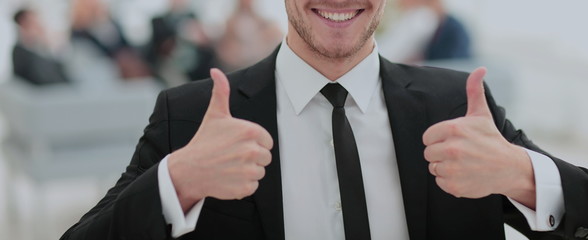Portrait of happy smiling  business man showing thumbs up