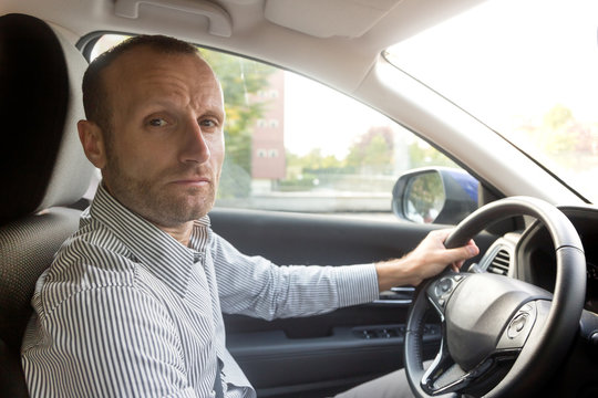 Stressed And Annoyed Male Driver On The Road During The Rush Hour