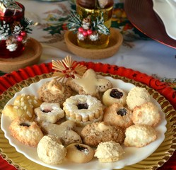 Lovely close up image of Christmas cookies on a red plate on a table.
