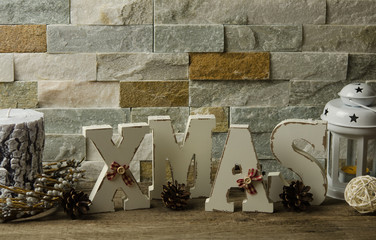 Christmas home decoration. Christmas still life decoration with wooden background. Xmas word on rustic background