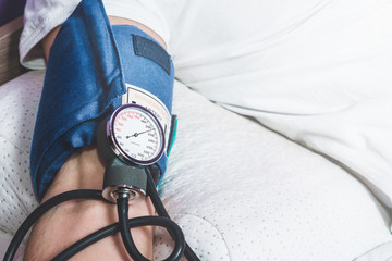 Test with a blood pressure meter. The man has the blood pressure tested. High score, hypertension....