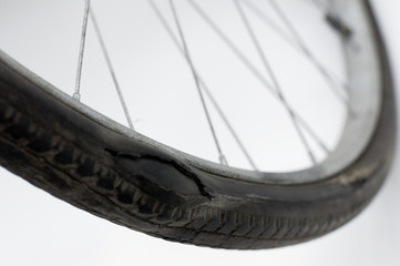 Old destroyed bicycle tire. - obrazy, fototapety, plakaty