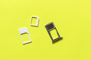 Adapters on a SIM card from larger to nano-sim with a SIM card in the slot