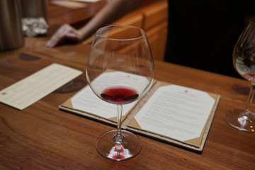 unfinished glass of a red wine with just a sip left