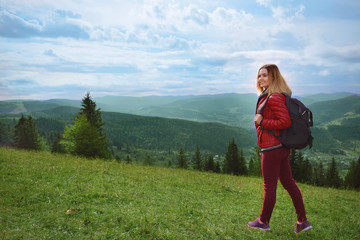 Beautiful female tourist in mountains