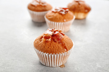 Tasty bacon muffin on table