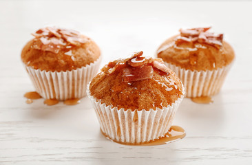 Tasty bacon muffins on table