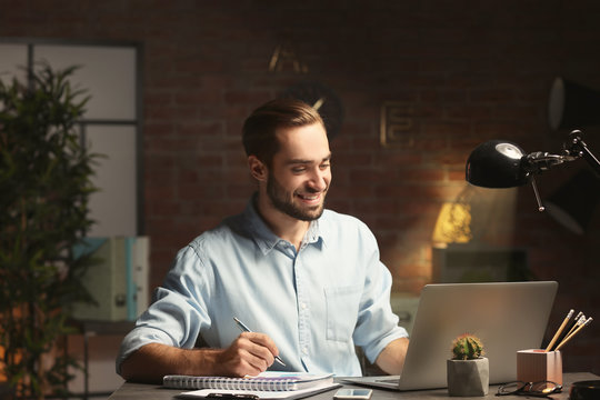 Young Man Working In Office At Night