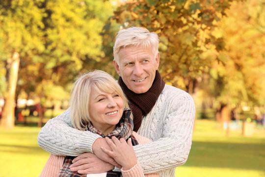 Cute elderly couple in autumn park