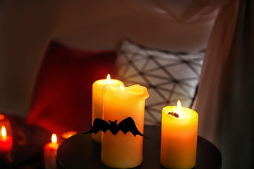 Creepy candles for Halloween on table indoors