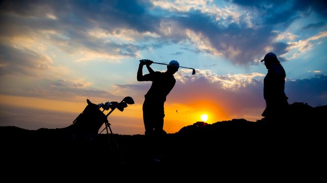Golfer Couple  Silhouette at Sunset