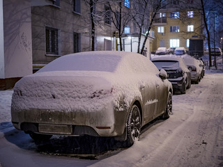 covered with snow parked car in winter.