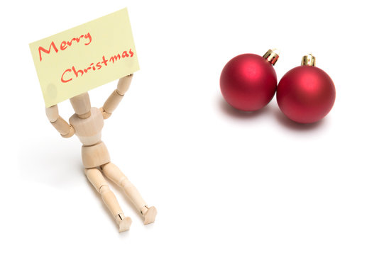 Joint dolls holding yellow notes with Merry Christmas and christmas ball