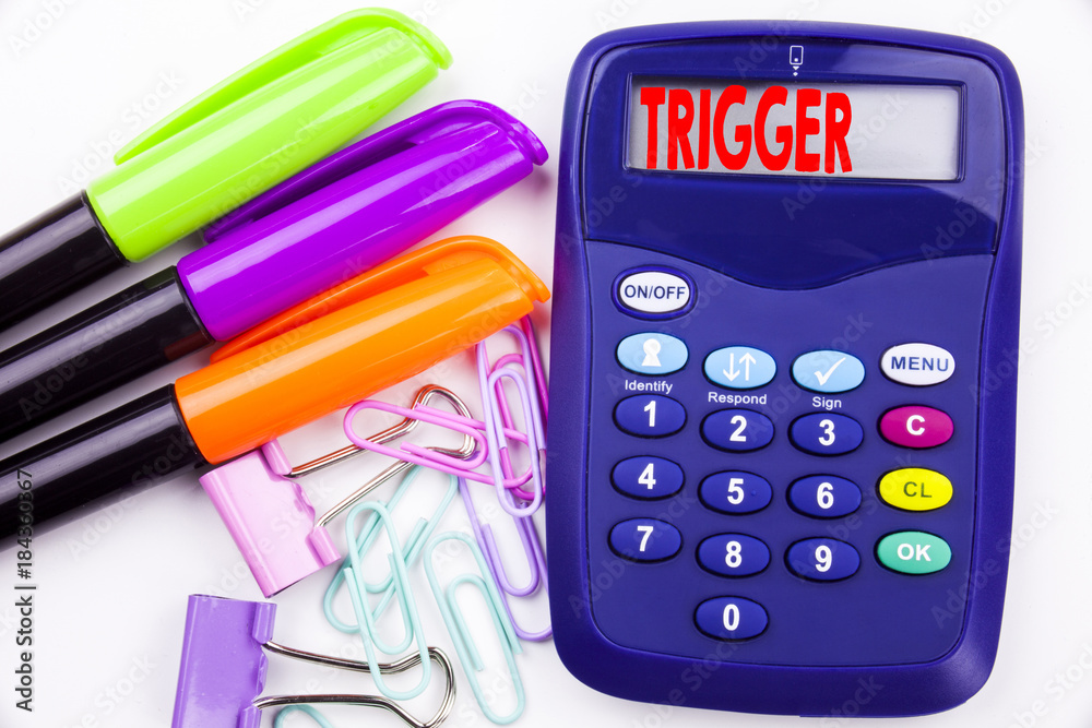 Fototapete writing word trigger text in the office with surroundings marker, pen writing on calculator. busines