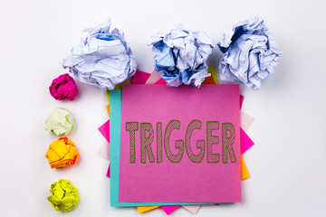 Writing text showing Trigger written on sticky note in office with screw paper balls. Business concept for Stir Spark Loose or Unleash Idea on the white isolated background.