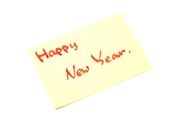 Happy new year writen on yellow sheet, white background