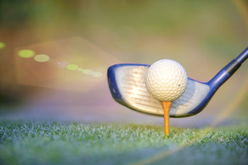golf ball on wooden tee ready to hit by the wood driver of golf player on the tee oof of the golf course