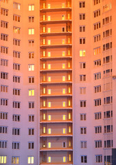Fototapeta premium electric light in the Windows of an apartment building