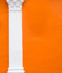 cement pole on orange wall © slonme