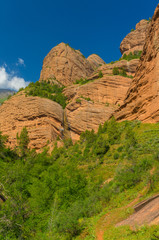 Rocks in mountains, blue sky and green vegetation in Kozhokelen