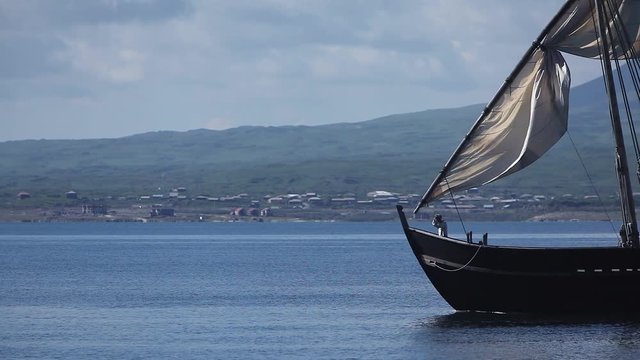 Sailboat floats in the sea or ocean, an old style ship on the water